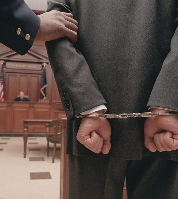 man in handcuffs standing in courtroom